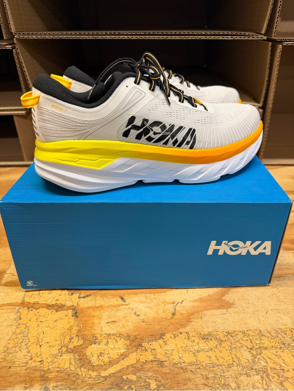 Hoka Men's Bondi 7 Running Shoes - White with Yellow and Orange Accents